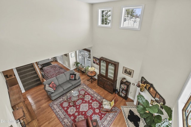 12 Alpine Trl Unit 12, Pittsfield, MA 01201 - living area featuring a towering ceiling, wood finished floors, and stairway