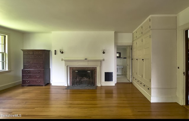 319 Under Mountain Rd, Lenox, MA 01240 - unfurnished living room featuring wood finished floors and a brick fireplace