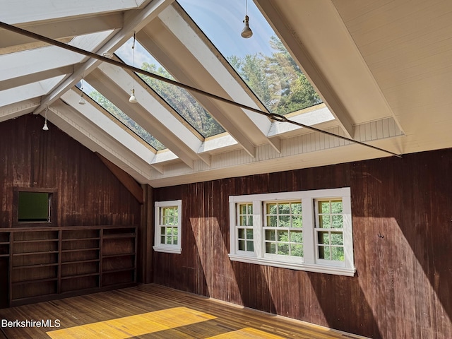 319 Under Mountain Rd, Lenox, MA 01240 - unfurnished living room with a skylight, wood walls, and wood finished floors