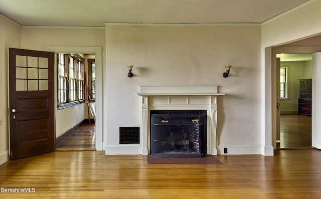 319 Under Mountain Rd, Lenox, MA 01240 - unfurnished living room featuring wood finished floors, ornamental molding, and a fireplace with flush hearth
