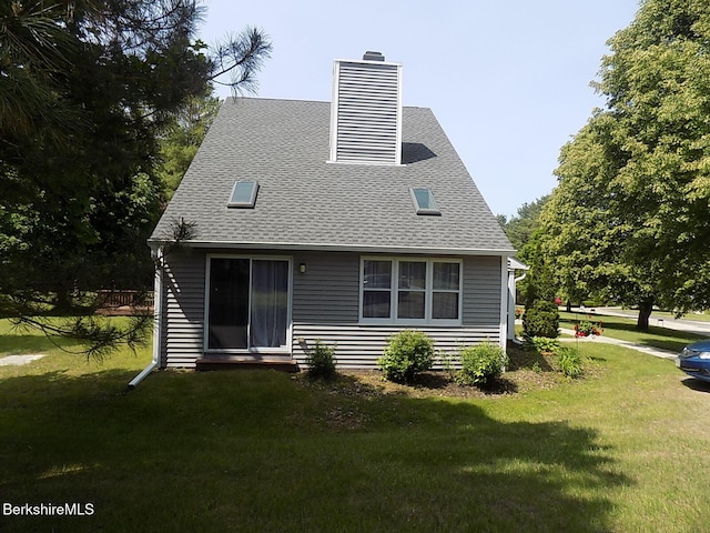 880 E St Unit 1A, Lee, MA 01238 - rear view of house with a chimney, roof with shingles, and a lawn