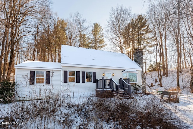 snow covered property featuring a wooden deck