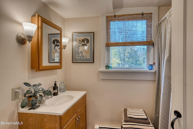 bathroom featuring walk in shower, vanity, and a baseboard heating unit