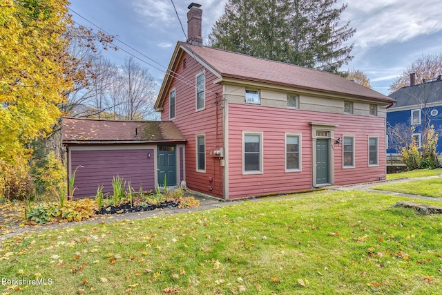 rear view of house featuring a lawn