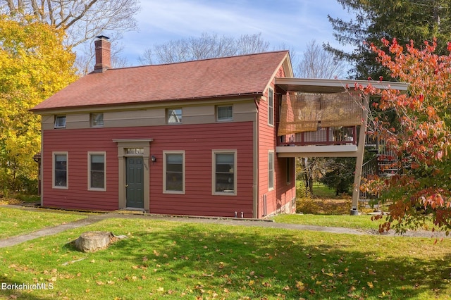 view of front of house featuring a front yard and a deck