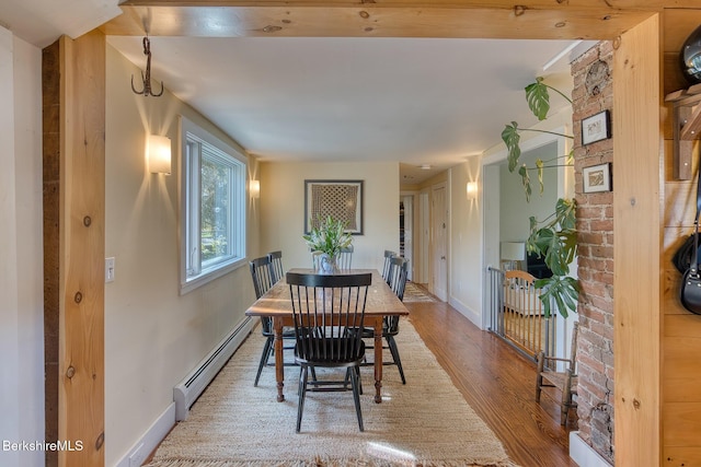 dining area featuring light hardwood / wood-style flooring and a baseboard heating unit