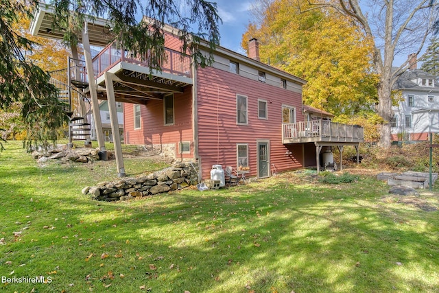 back of house with a yard and a wooden deck