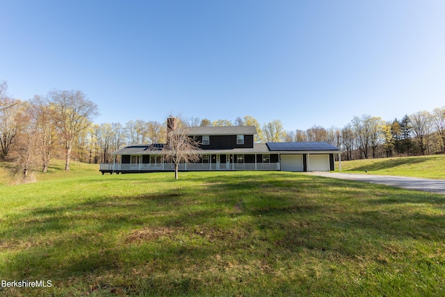 147 Brough Rd, Cheshire, MA 01225 - view of front of property with an attached garage, aphalt driveway, a porch, a front yard, and solar panels