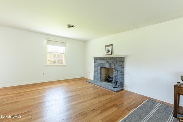 147 Brough Rd, Cheshire, MA 01225 - unfurnished living room featuring visible vents, baseboards, a fireplace, and light wood-type flooring