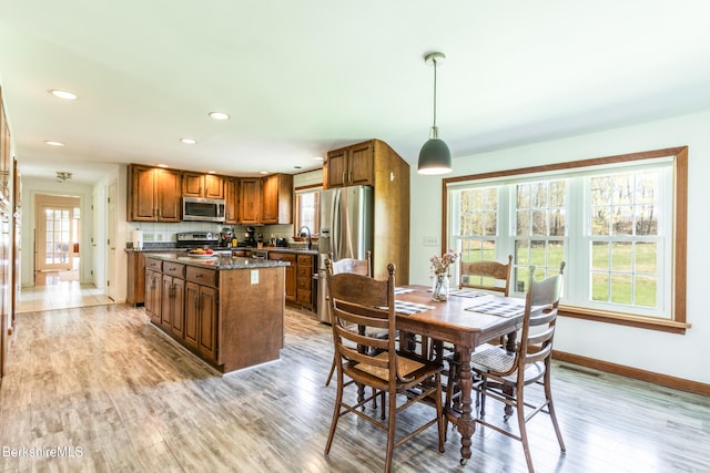147 Brough Rd, Cheshire, MA 01225 - kitchen featuring appliances with stainless steel finishes, a center island, light wood finished floors, and brown cabinetry
