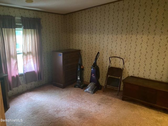 bedroom featuring carpet floors, multiple windows, ornamental molding, and wallpapered walls