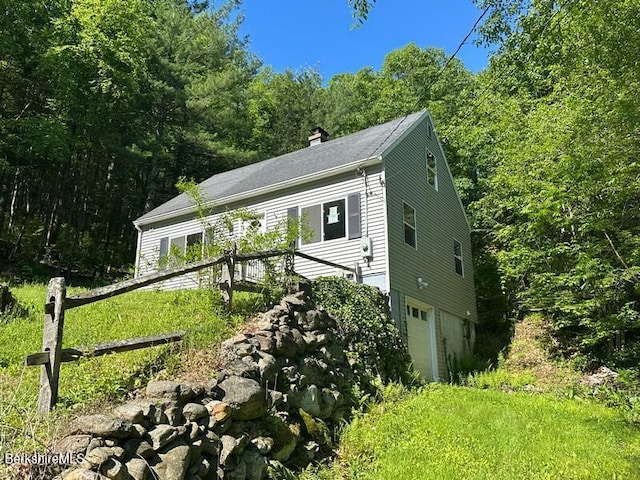9 Woronoco Rd, Blandford, MA 01008 - view of front of property featuring a chimney, an attached garage, and a view of trees