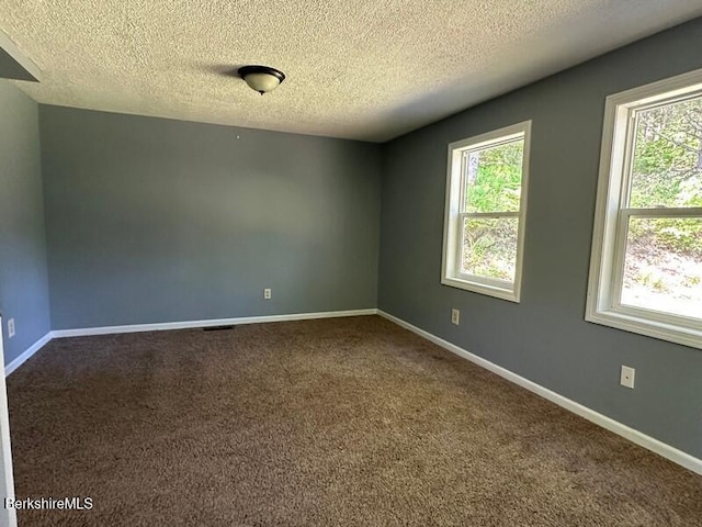 9 Woronoco Rd, Blandford, MA 01008 - spare room with a textured ceiling and dark carpet