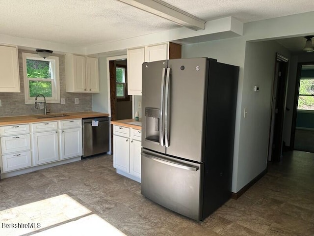 9 Woronoco Rd, Blandford, MA 01008 - kitchen featuring stainless steel appliances, butcher block countertops, a textured ceiling, white cabinetry, and decorative backsplash