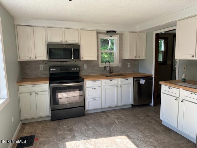 9 Woronoco Rd, Blandford, MA 01008 - kitchen featuring stainless steel appliances, butcher block countertops, backsplash, and white cabinets