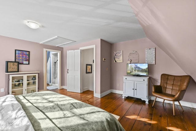 bedroom with baseboards, lofted ceiling, hardwood / wood-style flooring, and attic access