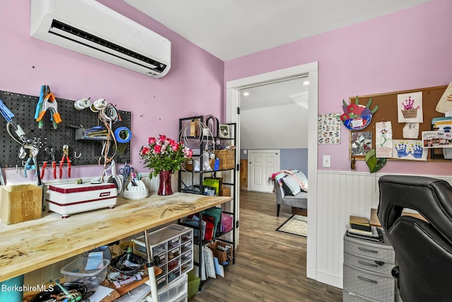 office with a wall unit AC, dark wood-style floors, and wainscoting