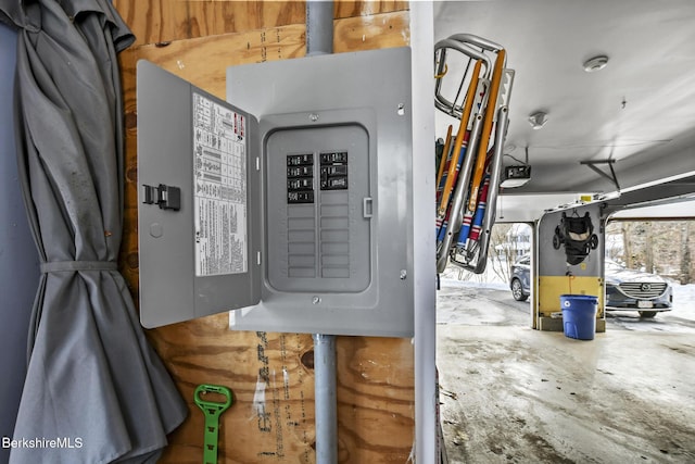 utility room featuring a garage and electric panel