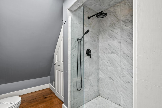 full bath with toilet, a shower stall, and wood finished floors