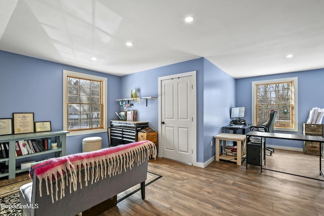 home office featuring recessed lighting, a healthy amount of sunlight, baseboards, and wood finished floors