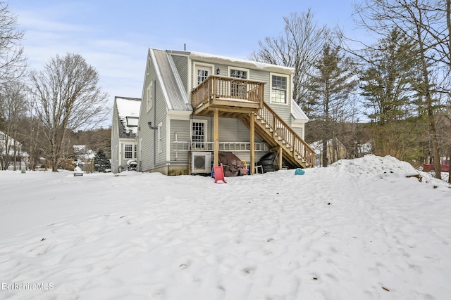 view of front of property with stairs, metal roof, and a wooden deck