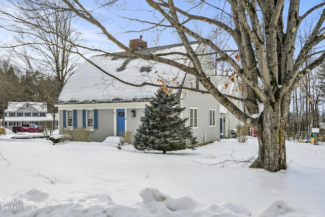 view of front facade featuring a chimney