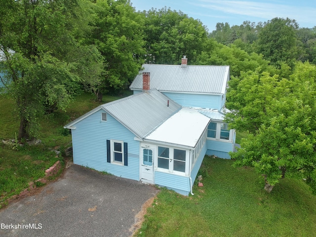 7 Hughes St, Adams, MA 01220 - view of front of property featuring a chimney, a metal roof, and asphalt driveway