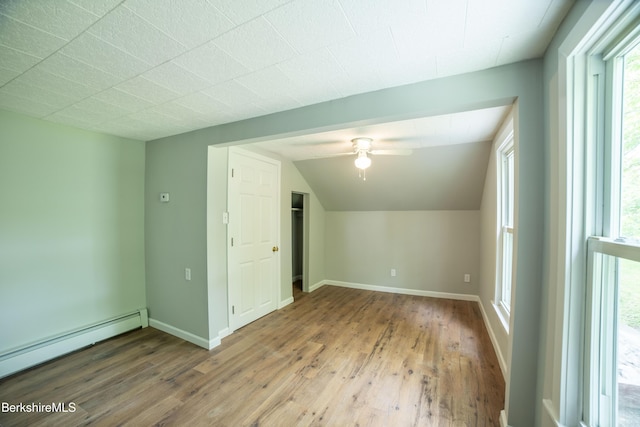 7 Hughes St, Adams, MA 01220 - additional living space with a baseboard heating unit, ceiling fan, wood finished floors, healthy amount of natural light, and lofted ceiling