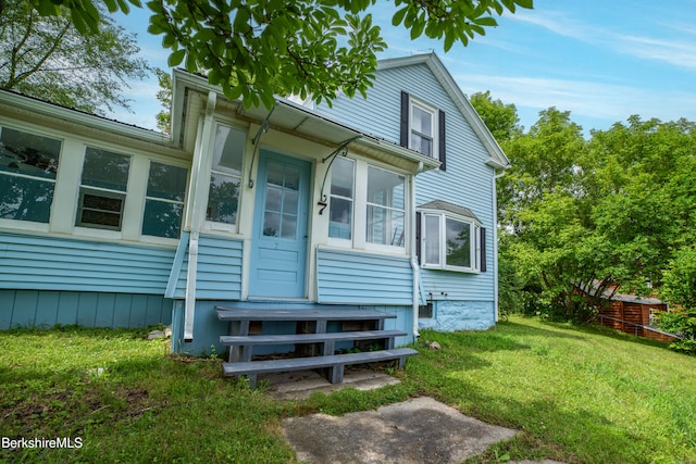 7 Hughes St, Adams, MA 01220 - view of front of home featuring a sunroom and a front yard