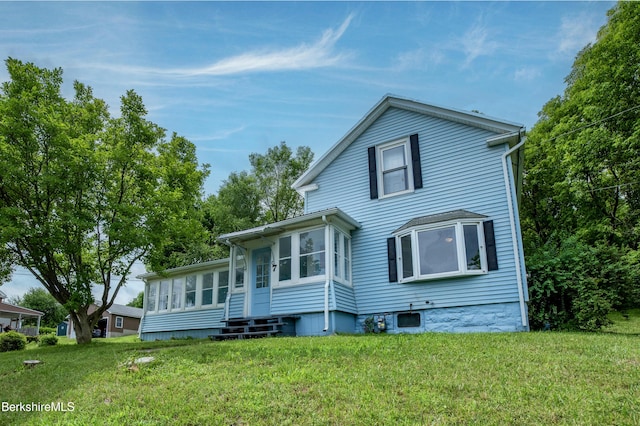 7 Hughes St, Adams, MA 01220 - view of front of property featuring a front yard, a sunroom, and entry steps