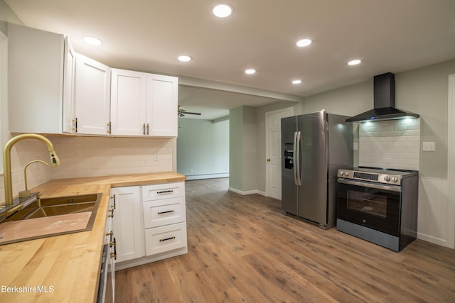 7 Hughes St, Adams, MA 01220 - kitchen featuring wood counters, wall chimney exhaust hood, oven, stainless steel refrigerator with ice dispenser, and wood finished floors