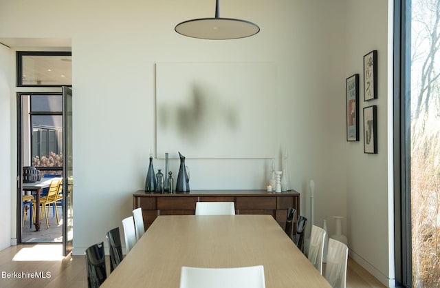 dining room with wood finished floors and a wealth of natural light