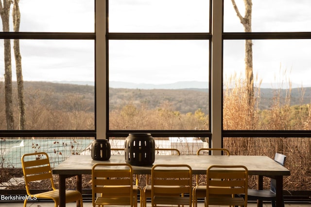 sunroom / solarium featuring a mountain view