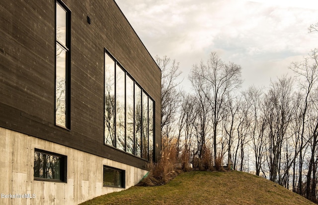 view of side of home with a lawn