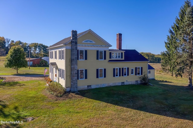 view of side of home with a lawn