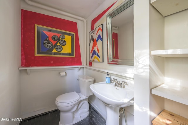half bath featuring a sink and toilet