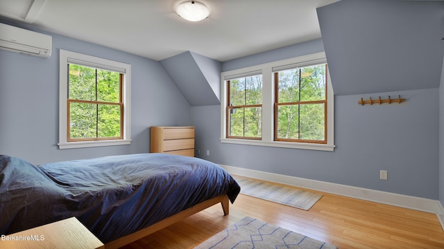 11 Jamie Ln, Sandisfield, MA 01255 - bedroom featuring a wall unit AC, baseboards, hardwood / wood-style flooring, and lofted ceiling