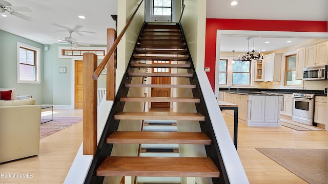 11 Jamie Ln, Sandisfield, MA 01255 - stairway with wood finished floors, plenty of natural light, ceiling fan, recessed lighting, and a chandelier
