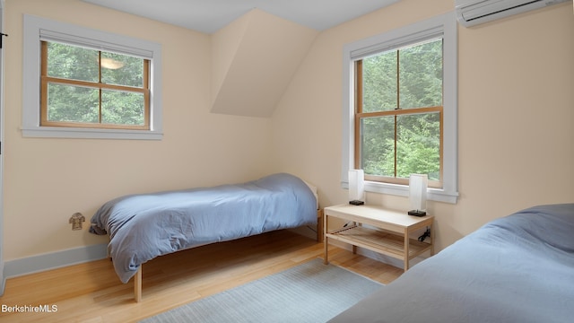 11 Jamie Ln, Sandisfield, MA 01255 - bedroom featuring multiple windows, wood finished floors, and a wall mounted AC