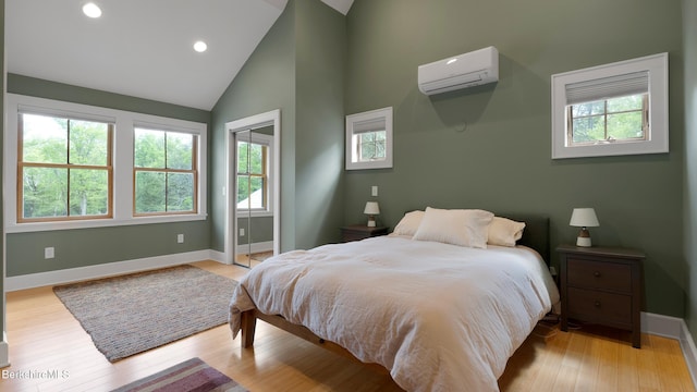 11 Jamie Ln, Sandisfield, MA 01255 - bedroom with a wall mounted AC, baseboards, light wood finished floors, recessed lighting, and high vaulted ceiling
