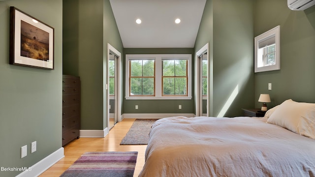 11 Jamie Ln, Sandisfield, MA 01255 - bedroom featuring an AC wall unit, light wood-type flooring, lofted ceiling, baseboards, and recessed lighting