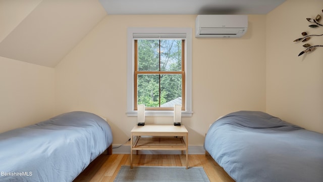 11 Jamie Ln, Sandisfield, MA 01255 - bedroom featuring a wall mounted AC, wood finished floors, lofted ceiling, and baseboards