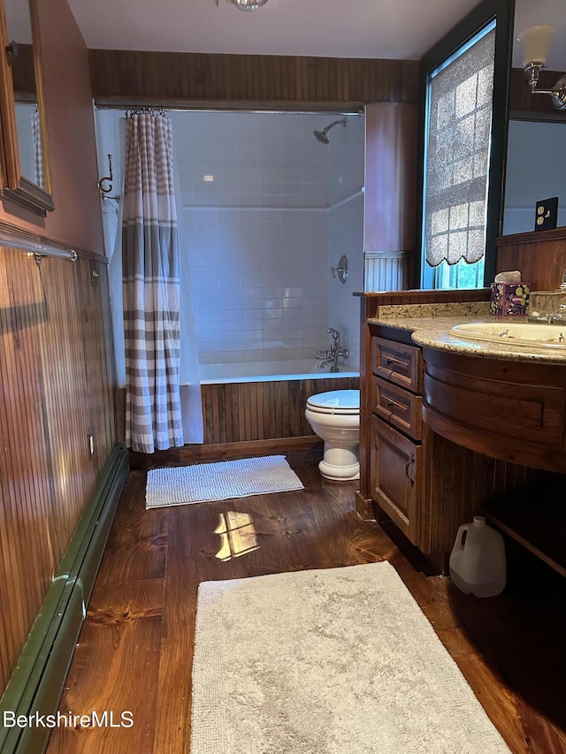 full bathroom featuring hardwood / wood-style floors, vanity, toilet, and shower / tub combo