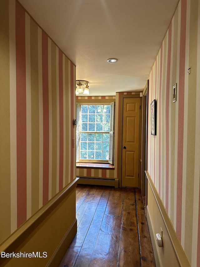 corridor featuring dark hardwood / wood-style floors and a baseboard heating unit