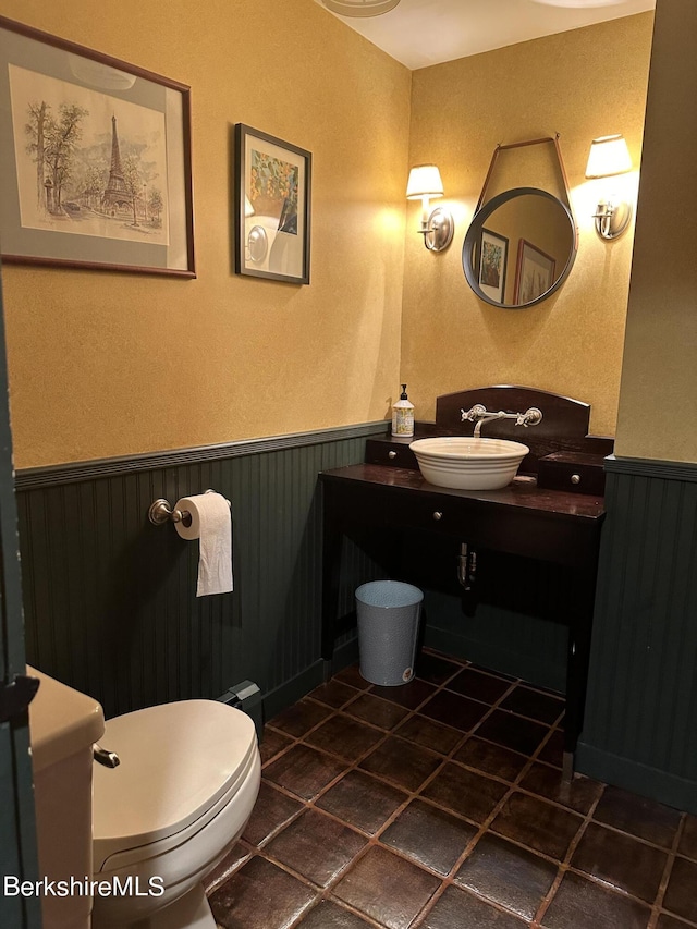 bathroom featuring tile patterned flooring, vanity, and toilet