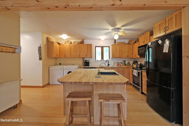 289 Algerie Rd, Becket, MA 01223 - kitchen featuring black appliances, separate washer and dryer, wooden counters, and light wood finished floors