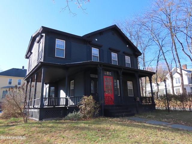 view of front of house with covered porch and a front lawn