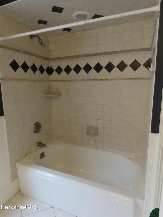 bathroom with tile patterned floors and  shower combination