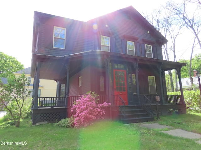 view of front of home featuring covered porch and a front yard