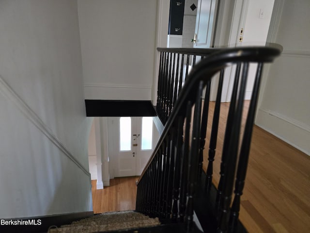 stairway featuring wood-type flooring